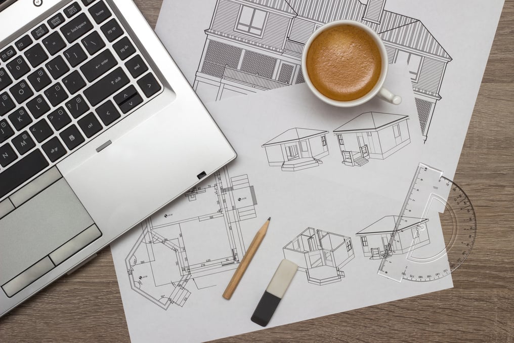 Architectural Blueprints with Coffee and Laptop Flatlay